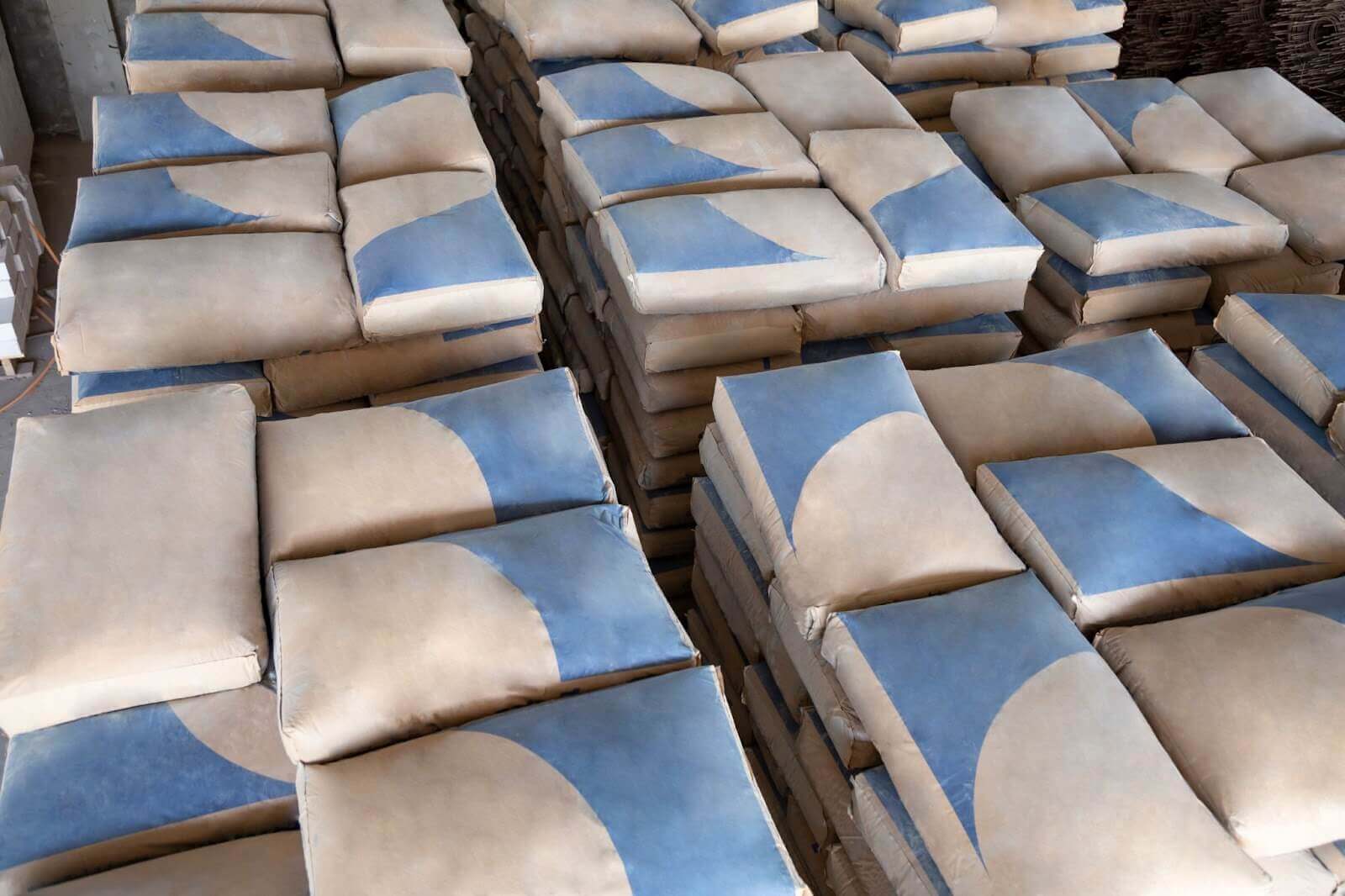 Brown and blue concrete bags laid on in stacks