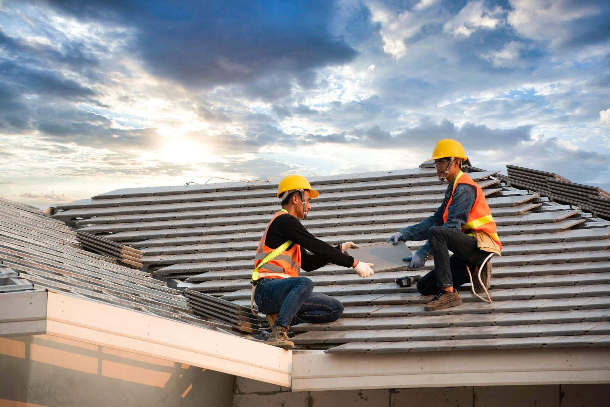 Two construction workers working on roof