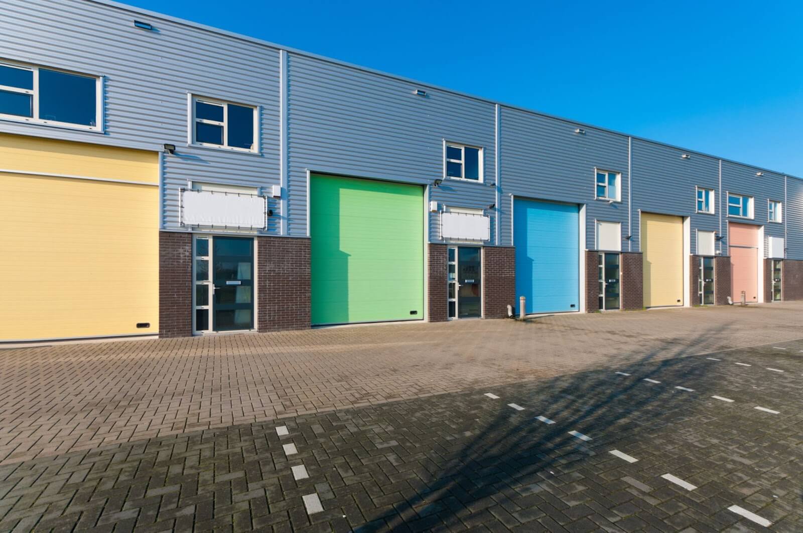 Silver warehouse with multicolored garage doors