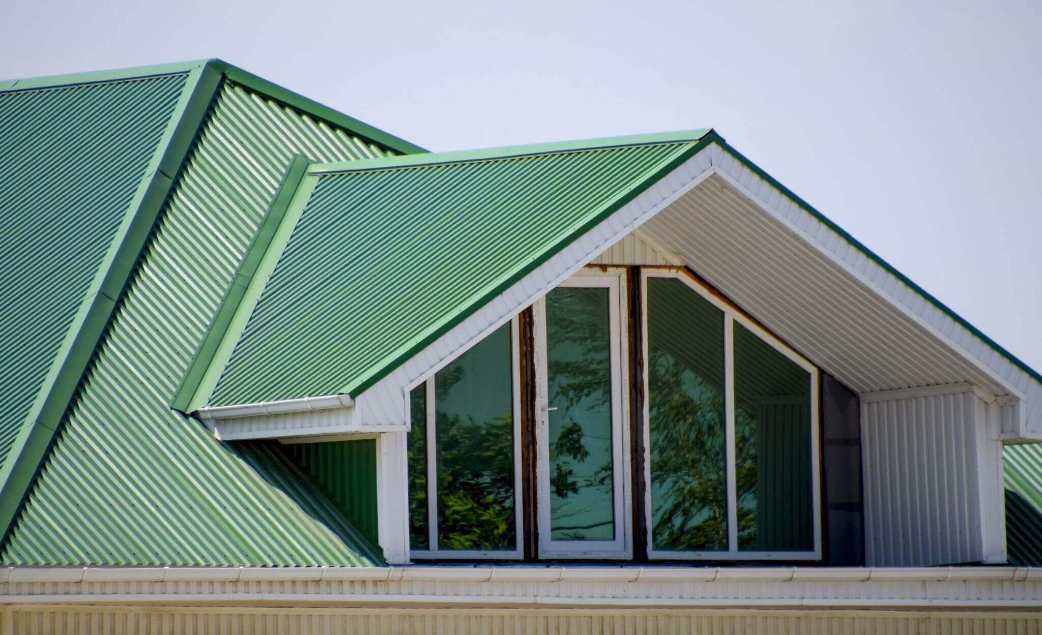 Green metal roof on building