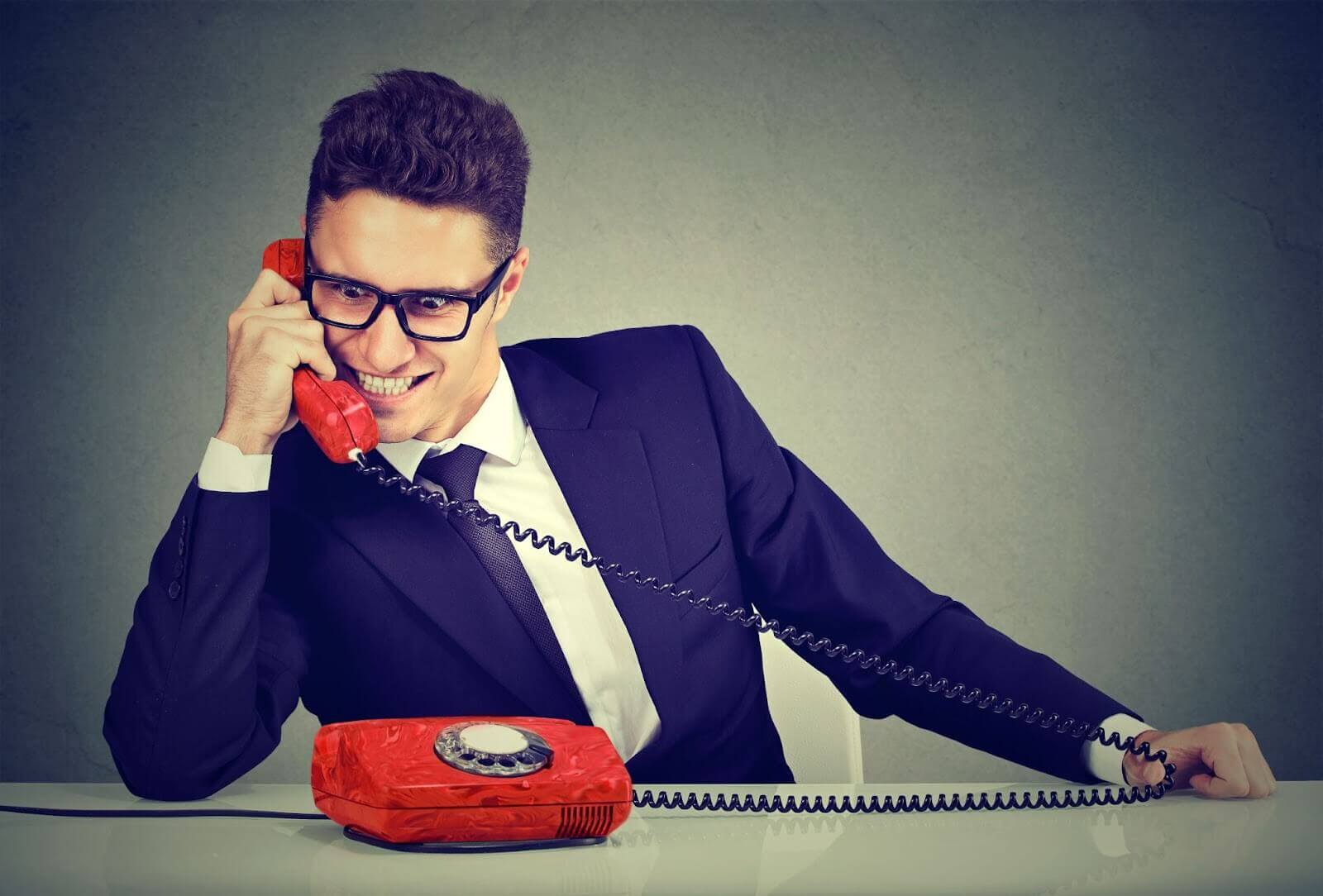 Salesman on phone with evil look on face
